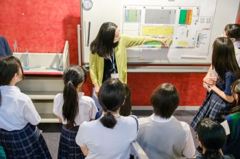 書庫について生徒さんたちに説明する図書室員